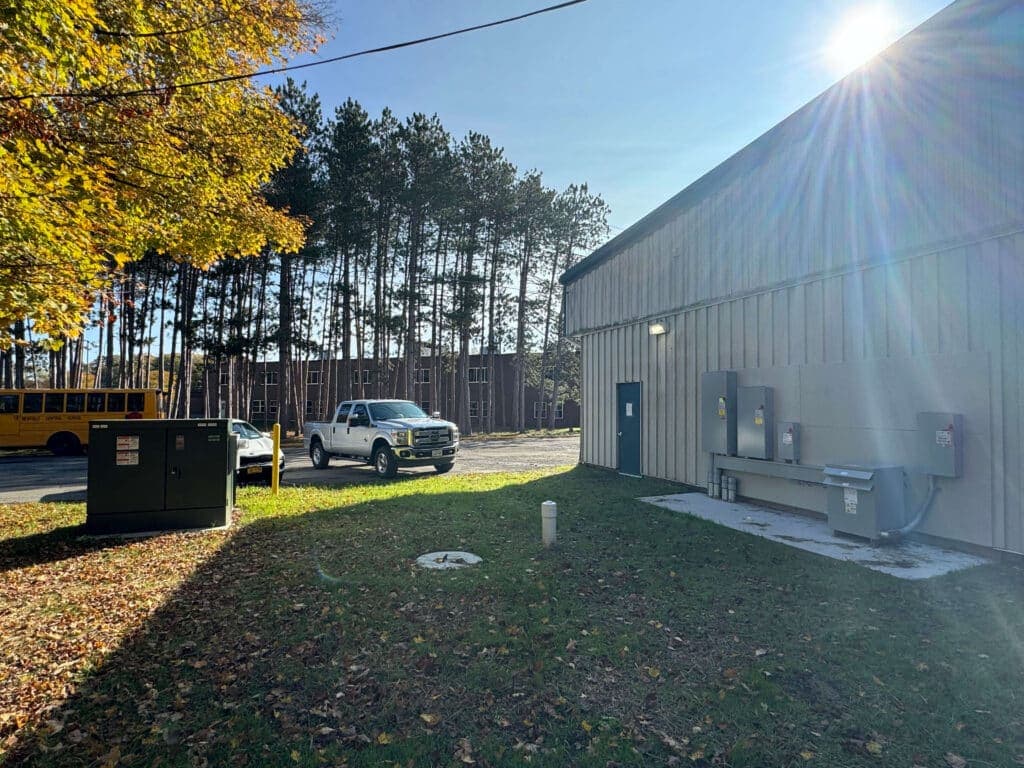 Utility area with truck, equipment, and trees in background, showcasing service environment.